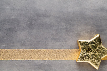 Christmas gold stars. Christmas pattern. Background on the gray color.の写真素材