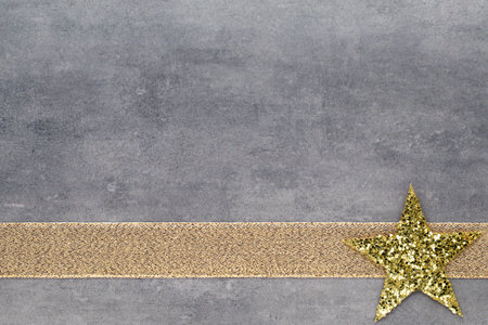 Christmas gold stars. Christmas pattern. Background on the gray color.