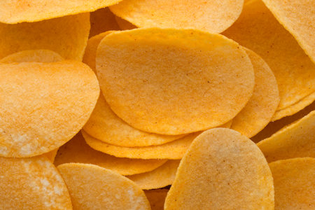 Rippled fresh organic potato chips background.