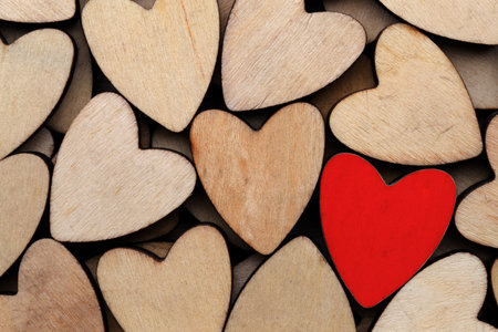 Wooden hearts, one red heart on the heart background.の写真素材