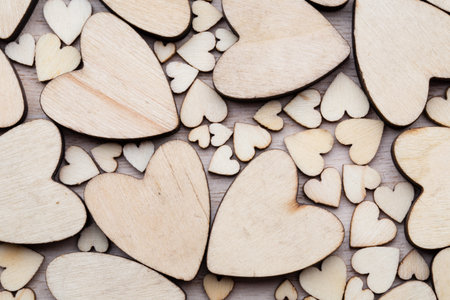 Wooden hearts, on the heart background.の写真素材