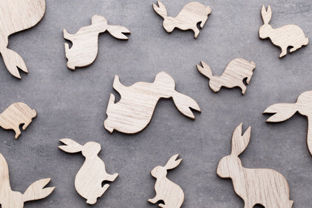 Handmade wood easter rabbits on wooden background.の写真素材