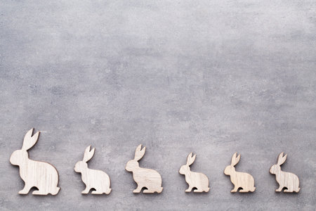 Handmade wood easter rabbits on wooden background.の写真素材