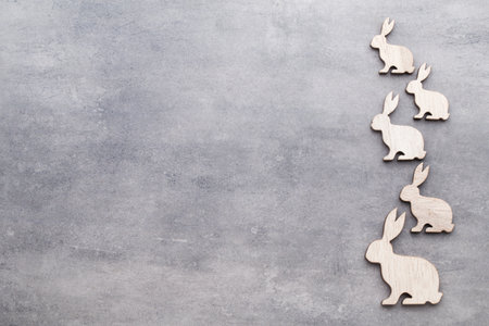 Handmade wood easter rabbits on wooden background.の写真素材