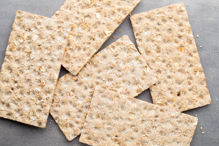 Stack of wholegrain crispy bread with sunflower, chia and sesames seedsの写真素材