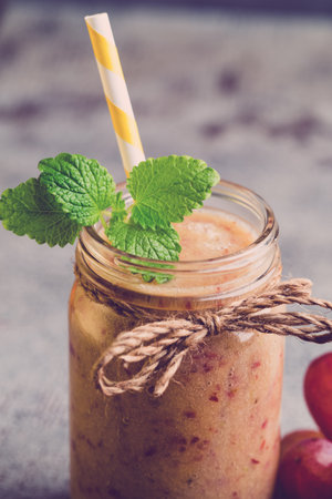 Grape smoothie, on the grey  background.の写真素材