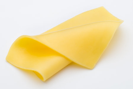 Cheese slices on white background cutout.の写真素材