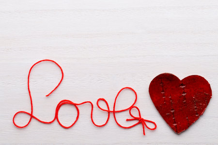 Happy Valentines Day. Red Heart on a wooden background.