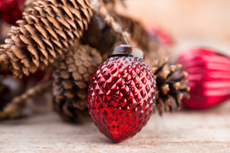 Christmas cone with red berries on a bokeh background.の写真素材