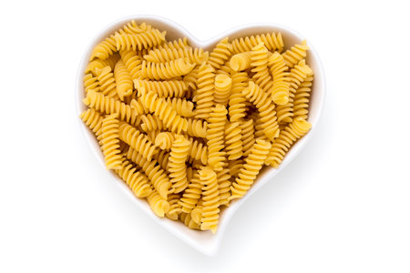 Uncooked fusilli pasta isolated white background.の写真素材