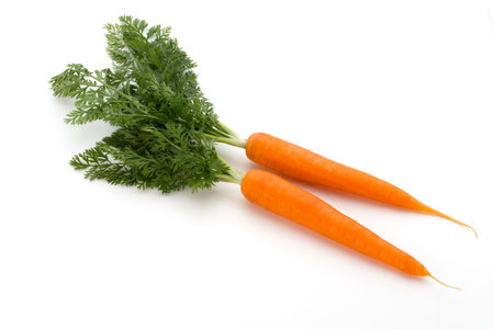 Carrot vegetable with leaves on the wooden background.の写真素材