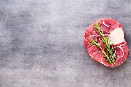 Raw fresh beef meat ribeye steak with spice and ingredients.の写真素材
