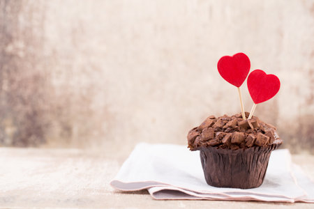 Chocolate muffins with heart vintage background, selective focus.の写真素材