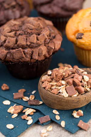 Chocolate muffins with chocolate vintage background, selective focus.