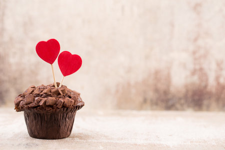 Chocolate muffins with heart vintage background, selective focus.の写真素材