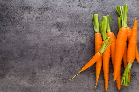Banches of fresh green asparagus,  and vegetables on wooden background, top view