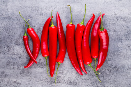 Chili cayenne pepper on grey background.の写真素材