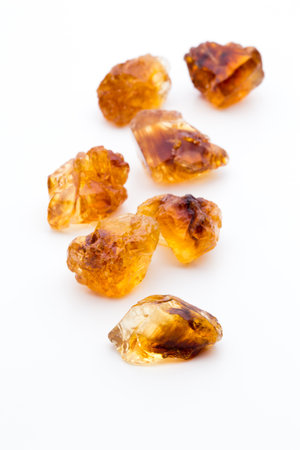 Brown caramelized lump cane sugar cube isolated on white background.