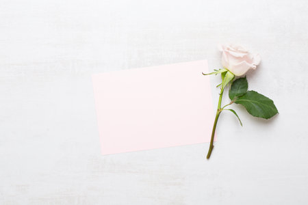 Flowers valentine day greeting card. Frame made of pink rose on gray background. Flat lay, top view, copy space.の写真素材
