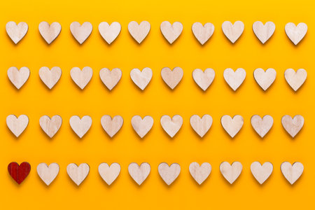 Small wooden hearts on a yellow background. A creative idea. Valentine day greeting card.