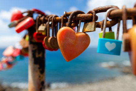 Puerto del Carmen beach in Lanzarote, Canary islands, Spain, heart shaped padlocks, blue sea.の写真素材