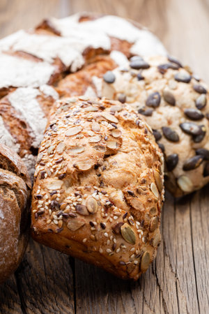 Bread background, top view of, black and rye loaves on black.