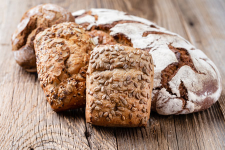 Bread background, top view of, black and rye loaves on black.
