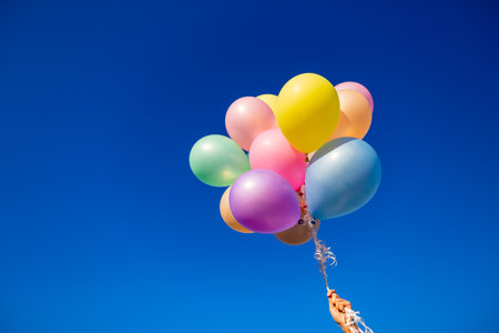Colorful balloons done with a retro filter effect. Concept of happy birth day in summer and wedding, honeymoon party use for background. Vintage color tone style.の写真素材