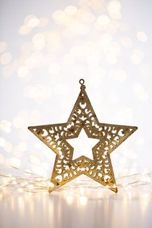 Christmas gold bokeh background with decorative star. Christmas gold stars. Christmas pattern.