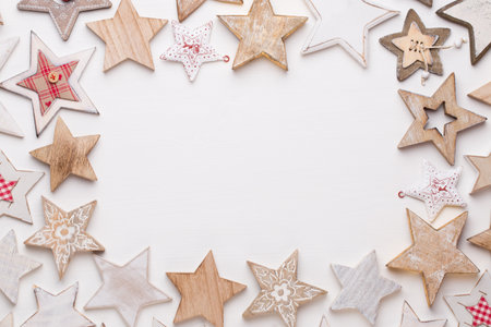 Christmas composition. Wooden decorations, stars on white background.  Flat lay, top view, copy space.の写真素材