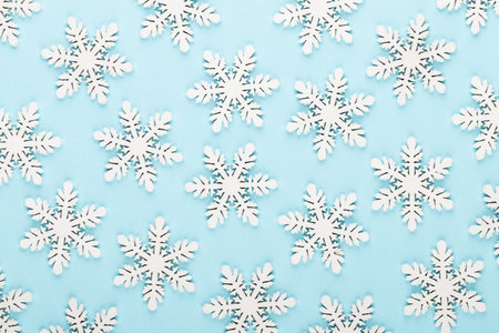 Christmas background. White snow decorations on a blue background.