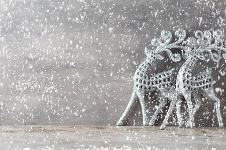 Silver deers on gray background. Christmas background.の写真素材