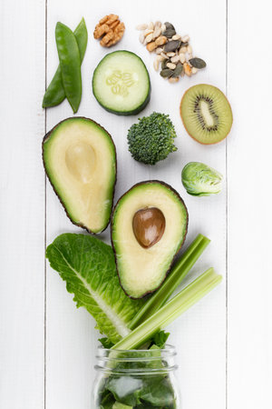 Glass jar mugs with green health vegetables lettuce leaves, lime, apple, kiwi, avocado, food concept.の写真素材