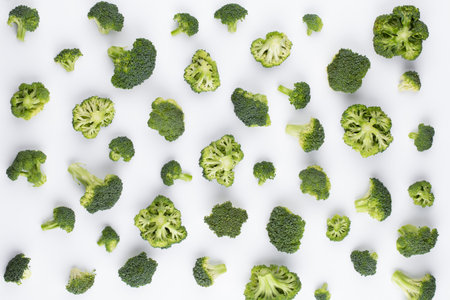 Broccoli pattern isolated on a white background. Various multiple parts of broccoli flower. Top view.の写真素材