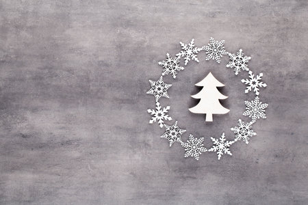 Christmas composition. White snow flakes wreath decorations on gray background. Christmas, winter, new year concept. Flat lay, top view, copy.の写真素材