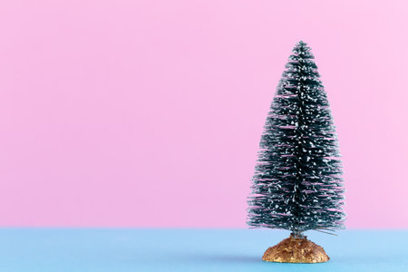 Christmas tree on pastel colored background. Christmas or New Year minimal concept.の写真素材