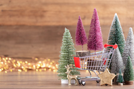 Colorful Christmas tree on wooden, bokeh background. Christmas holiday celebration concept. Greeting card.の写真素材