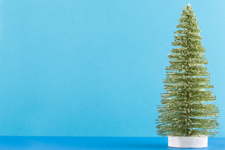 Christmas tree on pastel colored background. Christmas or New Year minimal concept.の写真素材