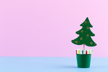 Christmas tree on pastel colored background. Christmas or New Year minimal concept.の写真素材