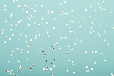 Glittering christmas background. Star dust and golden glitter. Holidays background for web and print.の写真素材