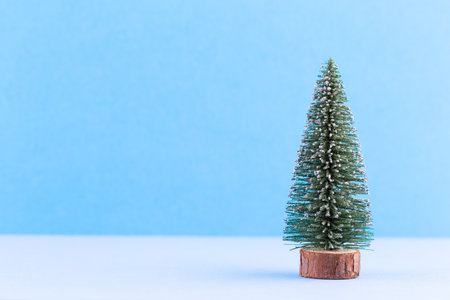 Christmas tree on pastel colored background. Christmas or New Year minimal concept.の写真素材