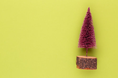 Christmas tree on pastel colored background. Christmas or New Year minimal concept.の写真素材
