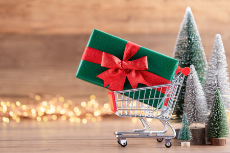 Colorful Christmas tree on wooden, bokeh background. Christmas holiday celebration concept. Greeting card.の写真素材