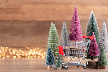 Colorful Christmas tree on wooden, bokeh background. Christmas holiday celebration concept. Greeting card.の写真素材