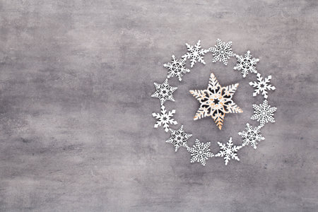 Christmas composition. White snow flakes wreath decorations on gray background. Christmas, winter, new year concept. Flat lay, top view, copy.の写真素材