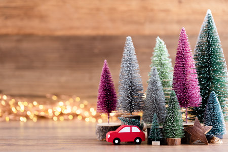 Colorful Christmas tree on wooden, bokeh background. Christmas holiday celebration concept. Greeting card.の写真素材