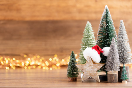 Colorful Christmas tree on wooden, bokeh background. Christmas holiday celebration concept. Greeting card.の写真素材