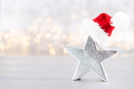 Christmas star, decor on bokeh silver background. Christmas or New Year minimal concept.の写真素材