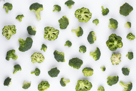 Broccoli pattern isolated on a white background. Various multiple parts of broccoli flower. Top view.の写真素材