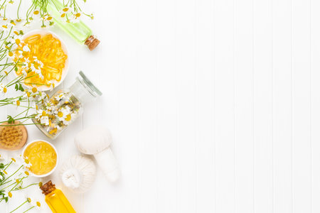 Composition aromatherapy with natural cosmetics and chamomile flowers on light background.の写真素材